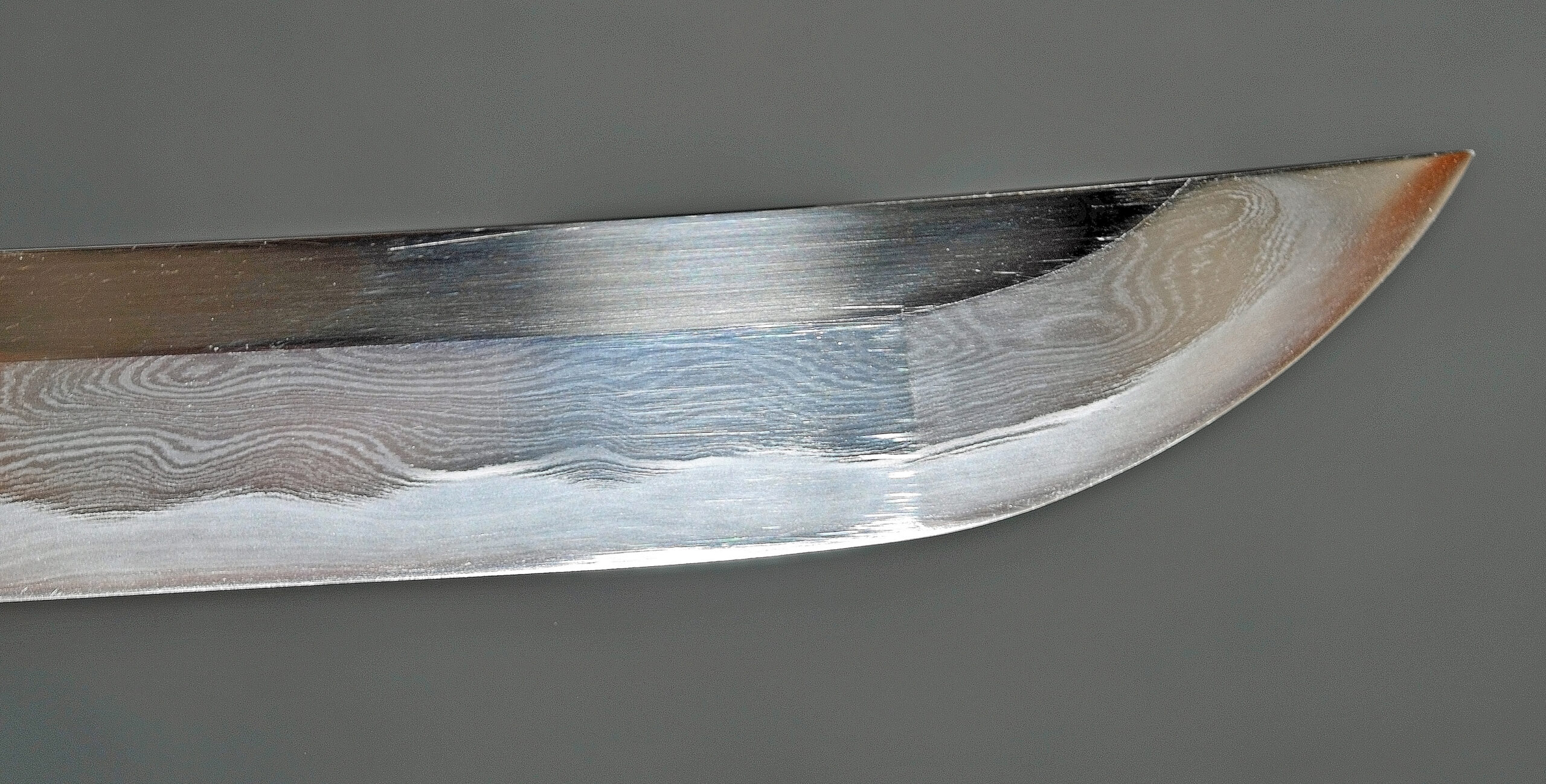 Close-up of a katana kissaki showing hamon and boshi temper line